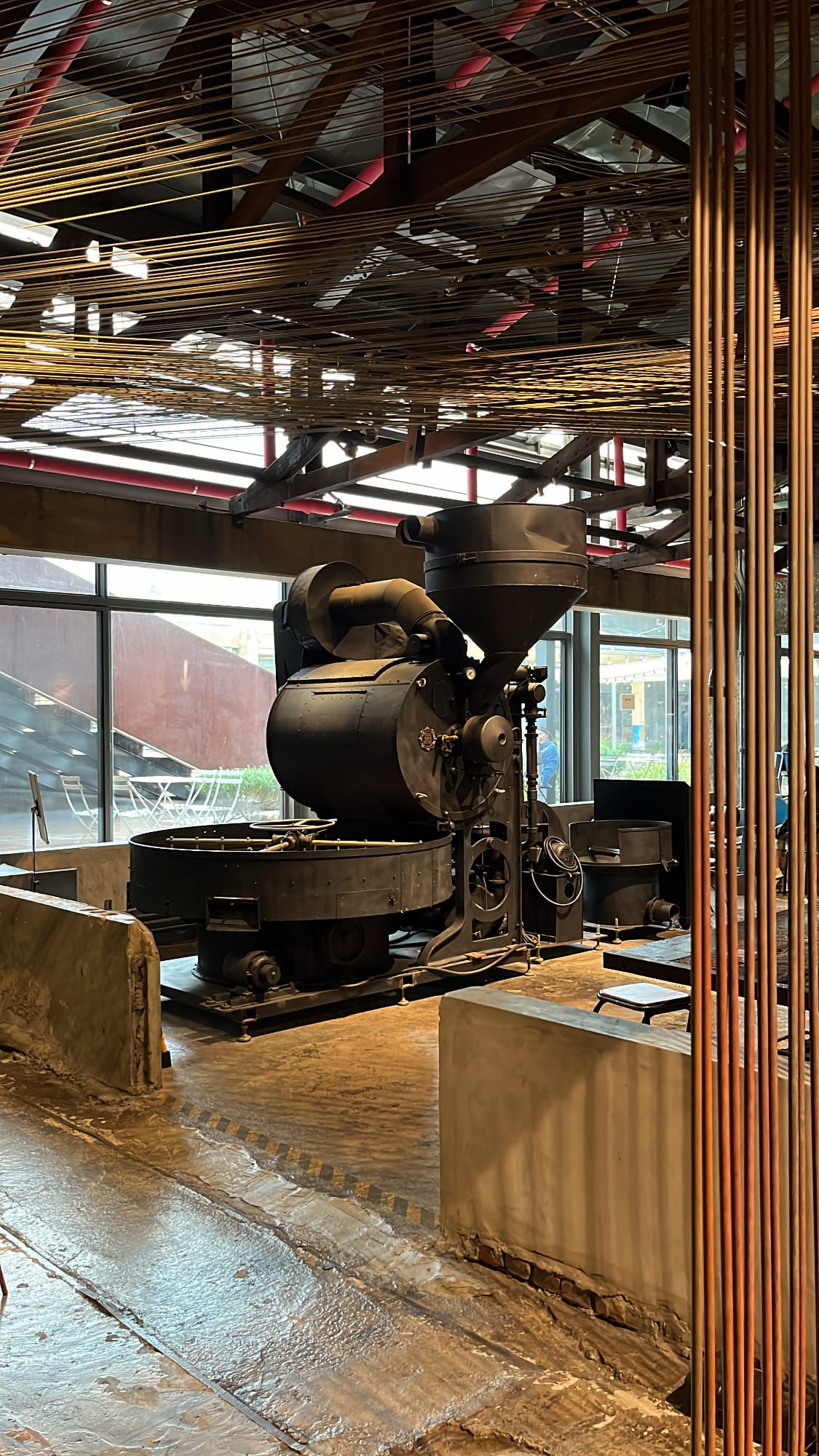 Massive vintage coffee roasting machine centerpiece at Terarosa Suyeong