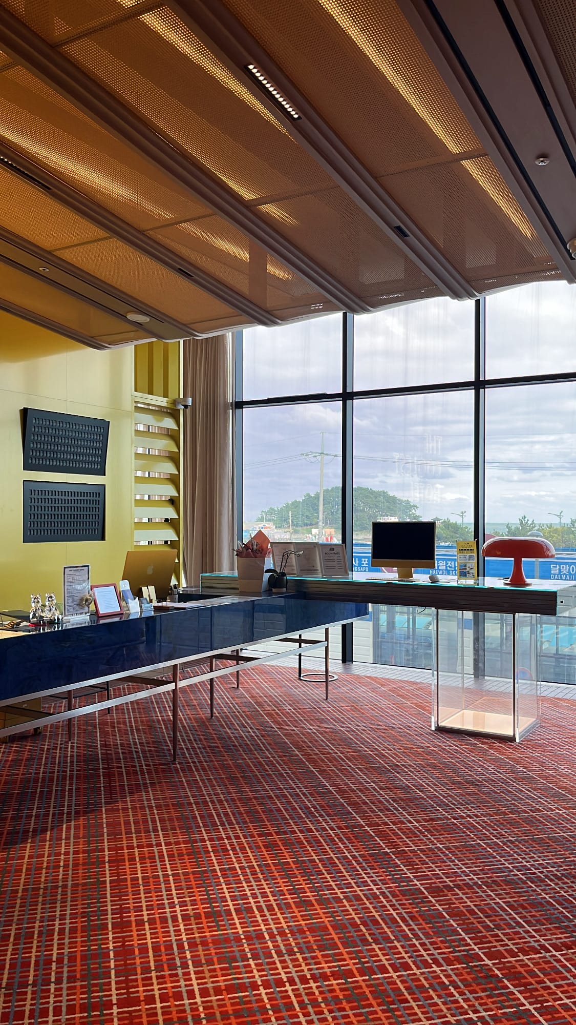 Panoramic floor-to-ceiling glass windows at The Coolest Hotel lobby