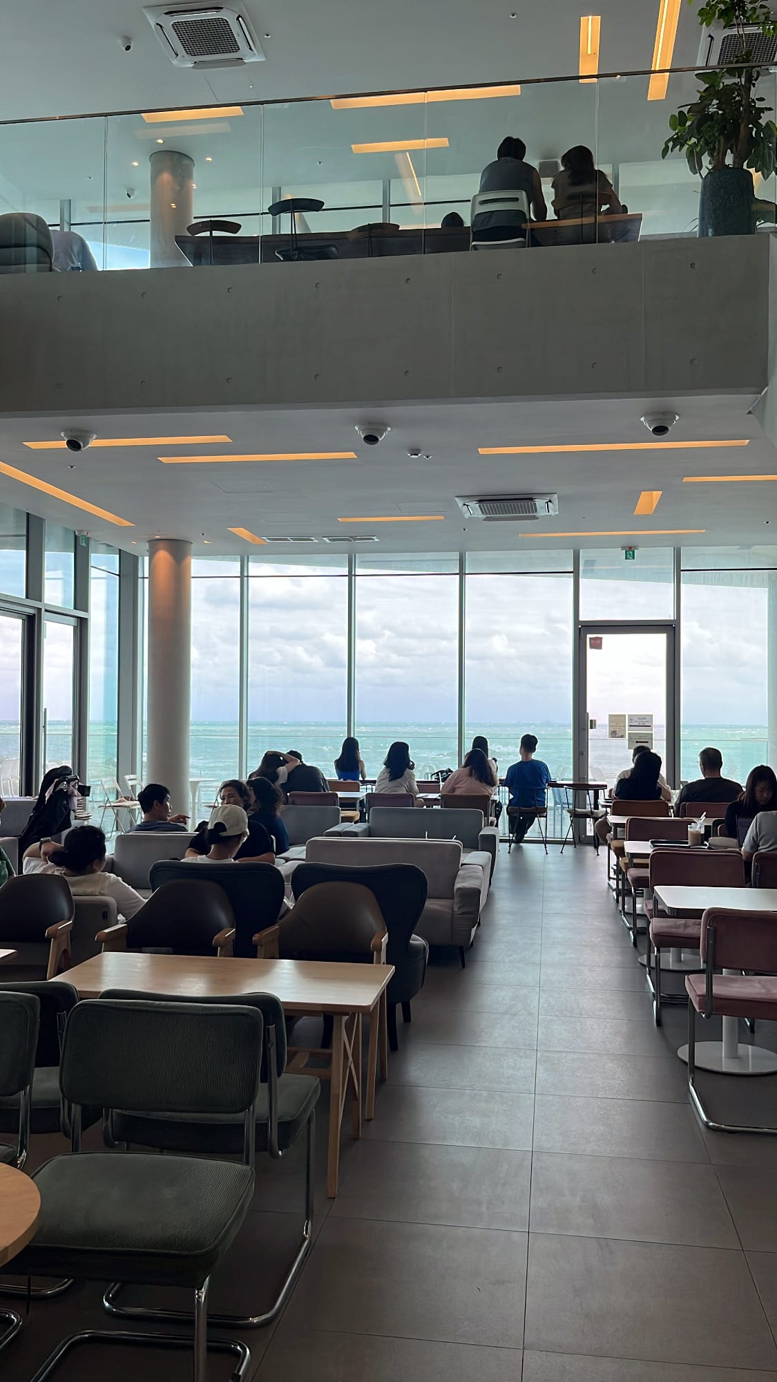 Expansive indoor seating hall on the first floor facing the ocean at Coralani Busan