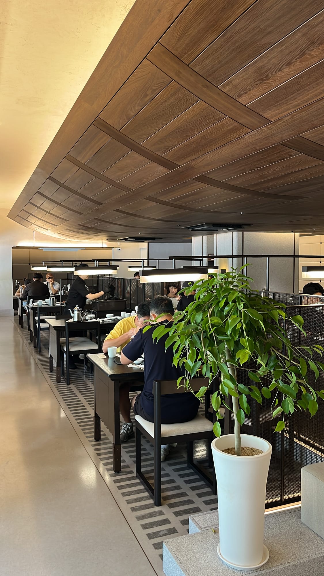 Wide interior dining room featuring curved wooden ceiling at Geodae Gomtang Busan