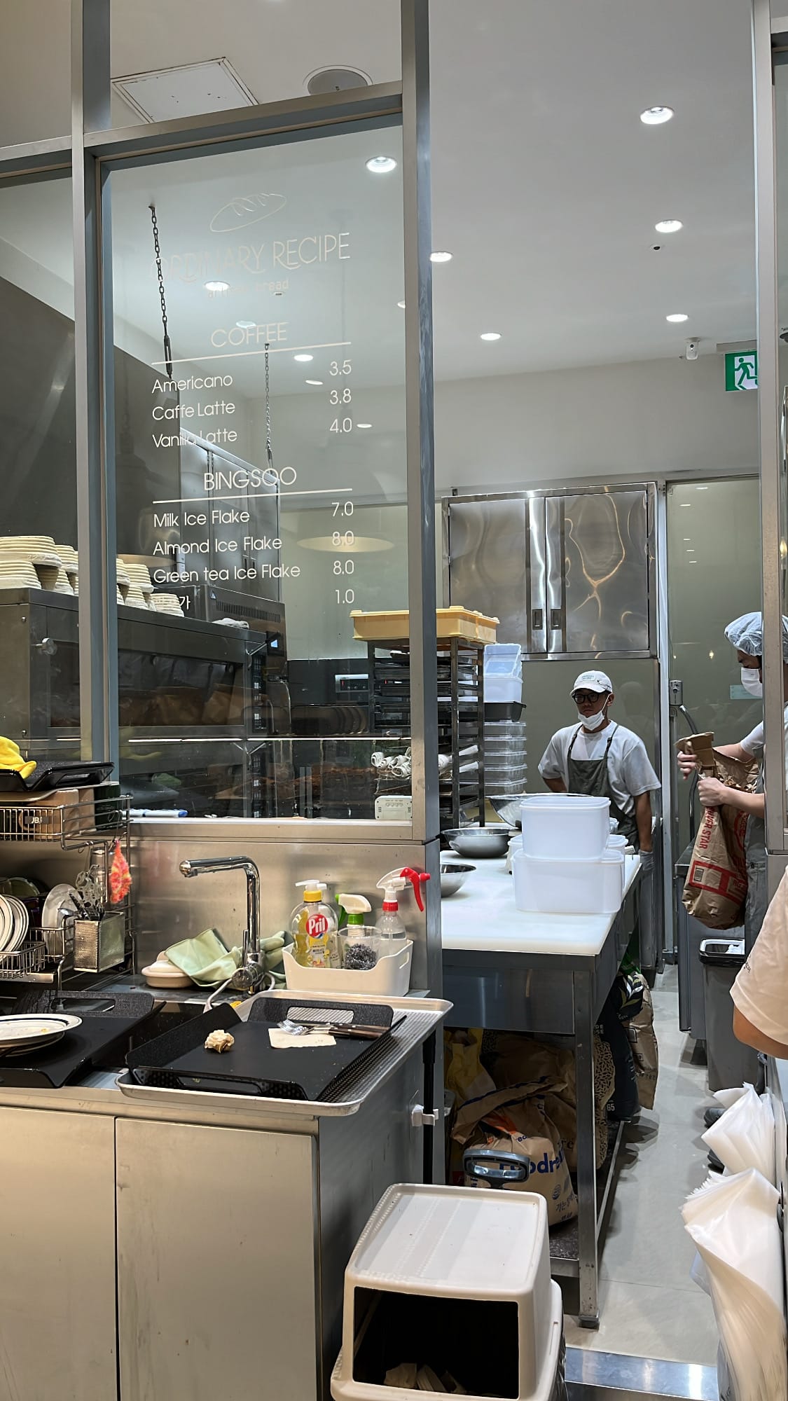 Open baking kitchen and glass drink menu display at Ordinary Recipe Centum bakery cafe