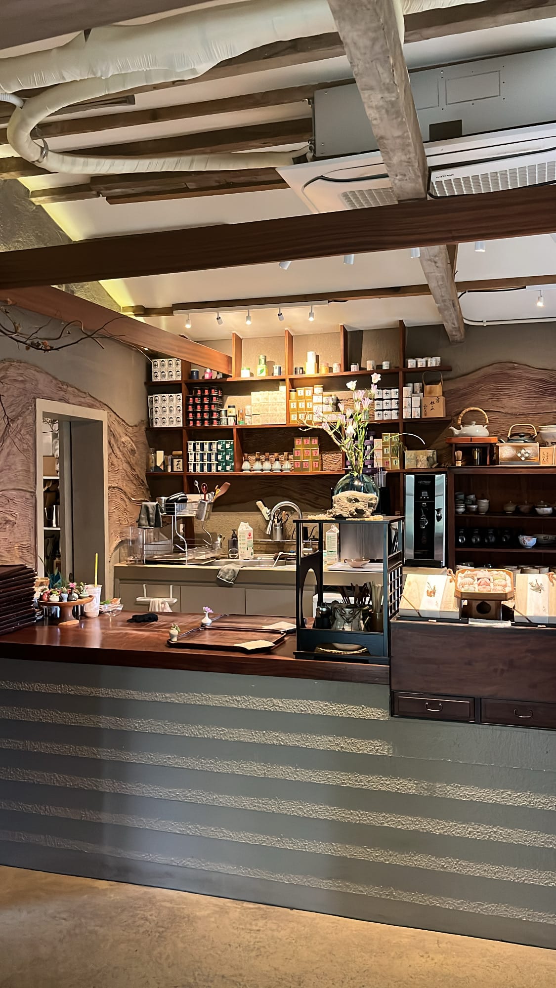 Order counter showcasing tea tins and ceramics inside Simmian Busan
