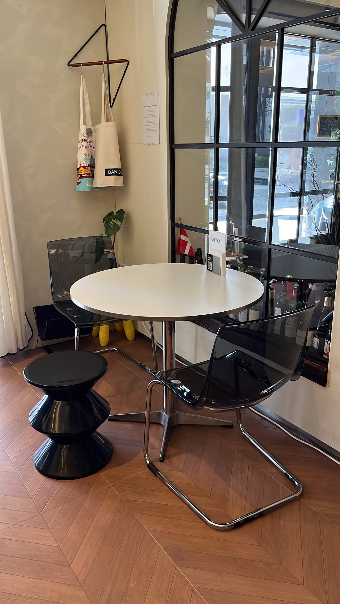 Danicci round cafe table set beside black grid arch mirror