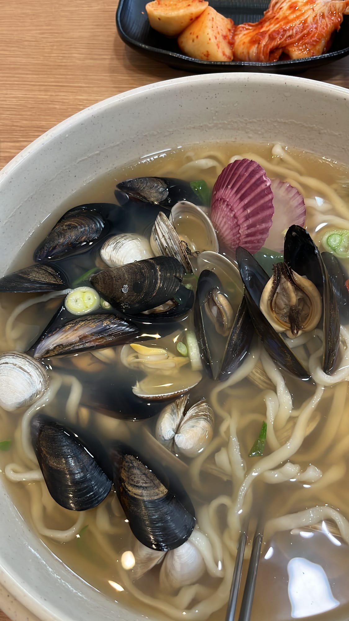Steaming bowl brimming with clams, mussels, and noodles at Haeundae 31cm Seafood Kalguksu