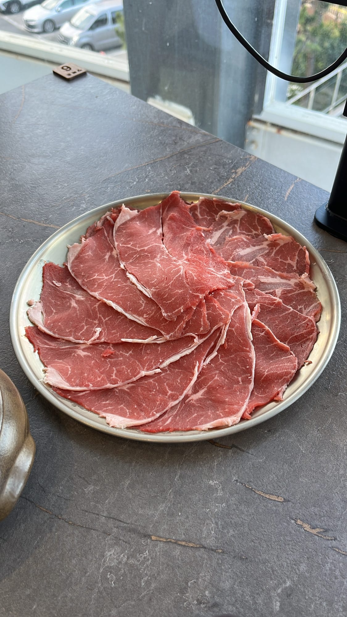Fresh thinly sliced red beef plate for shabu-shabu at Jang Deuk Chun