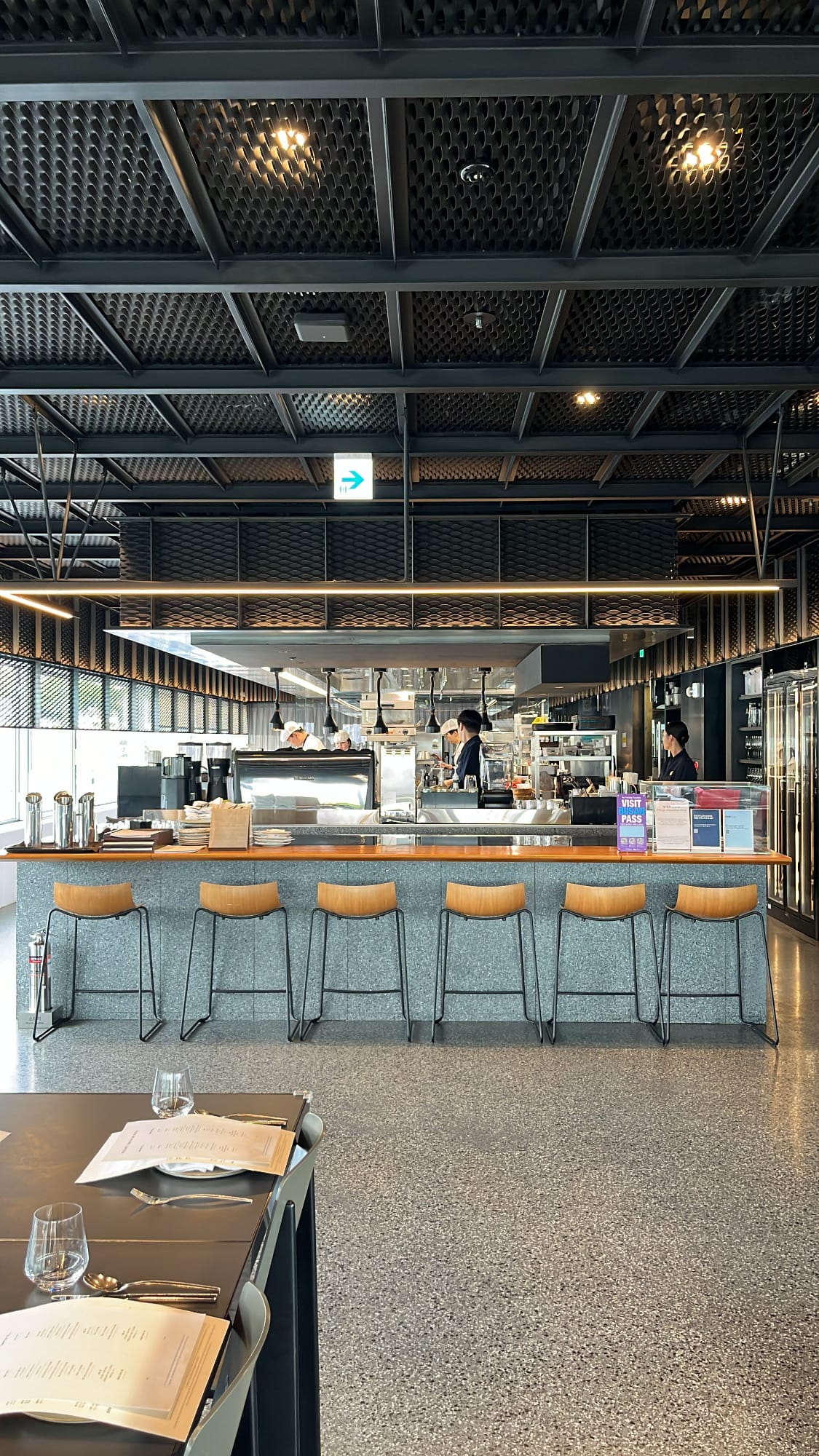 Modern beverage bar counter and wooden stools at Michael's Urban Farm Table