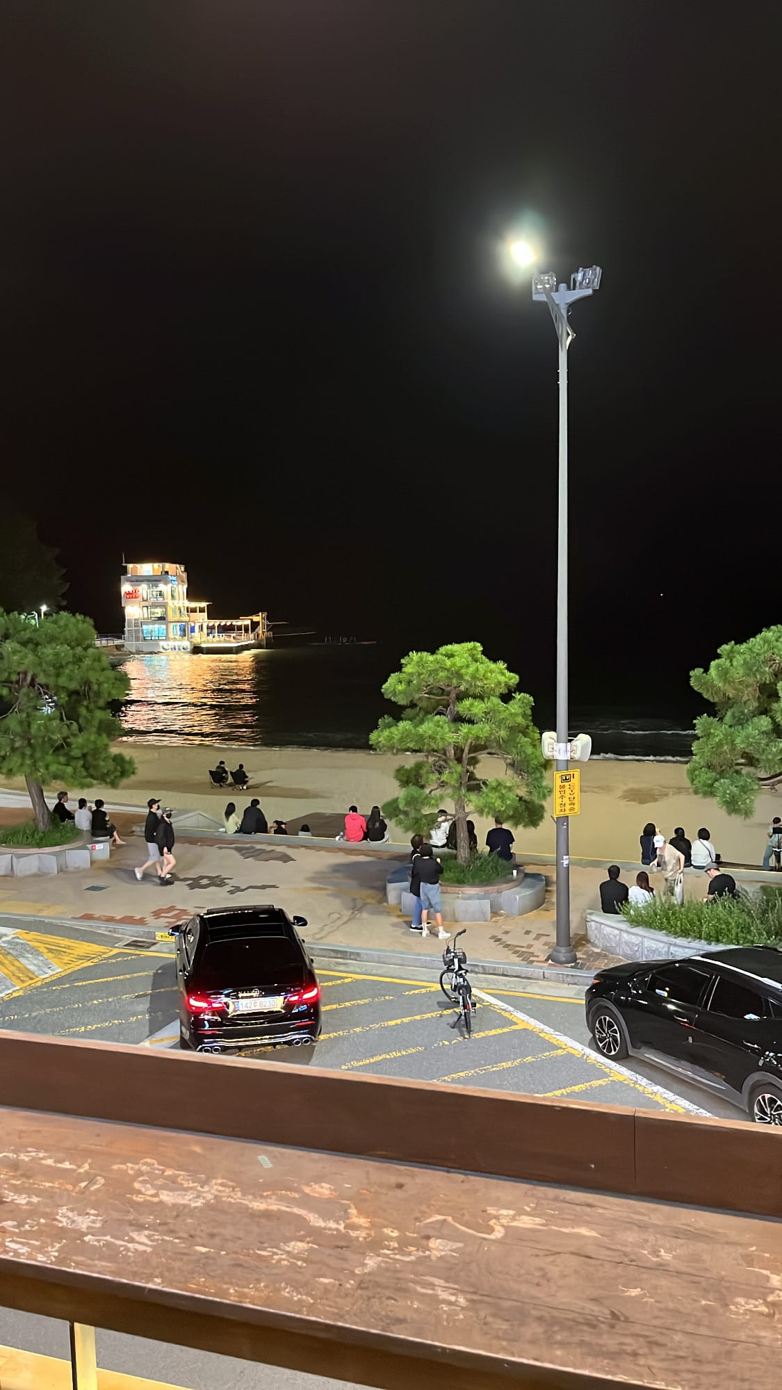 Night street view of Songjeong beach area filled with visitors