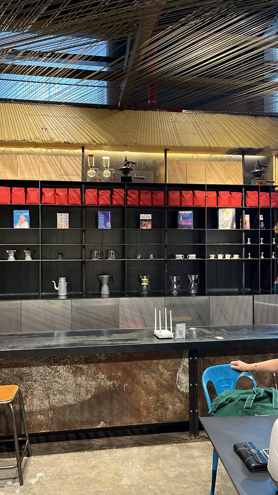 Terarosa Coffee retail display shelves with signature red bean bags