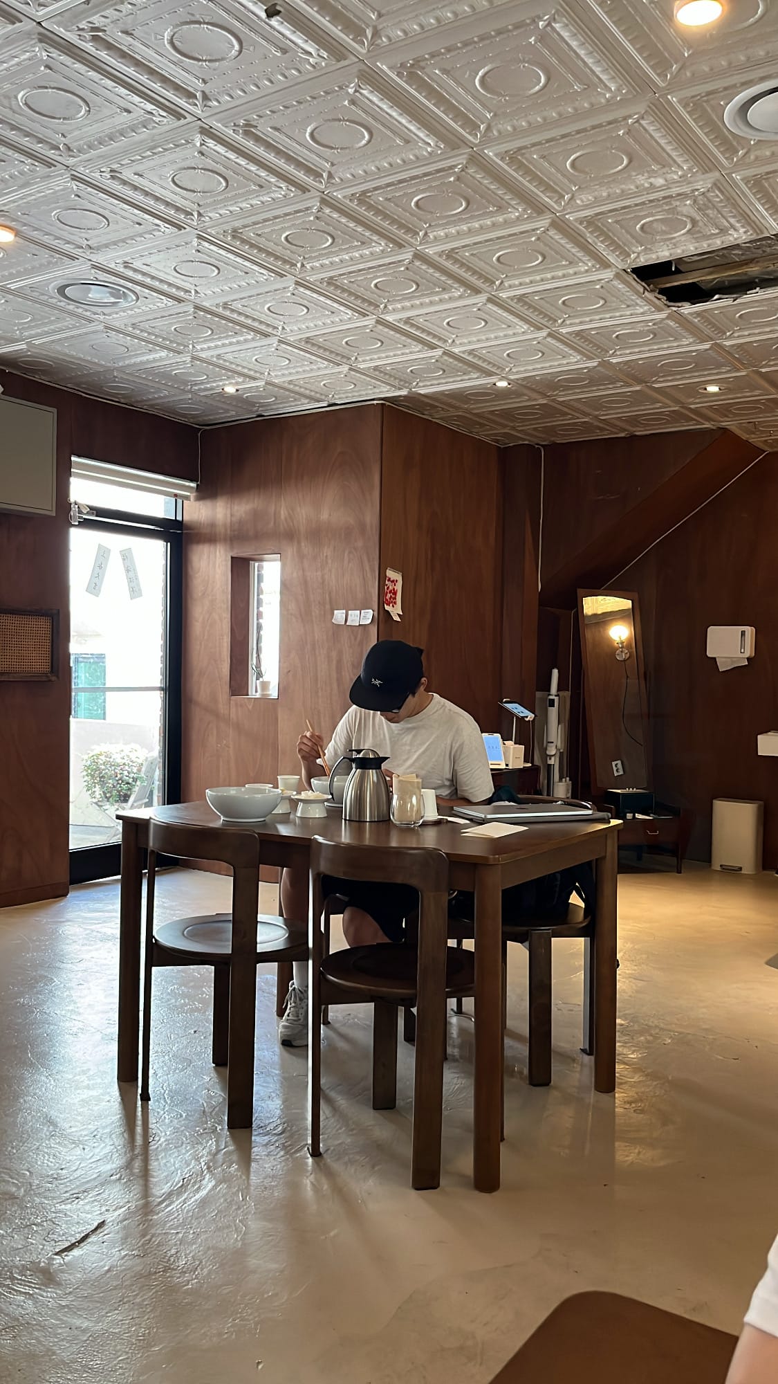 Cozy indoor corner seating enclosed by warm wood panels at Yangkyungoak Busan
