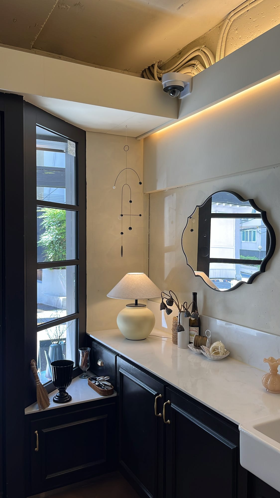 Danicci aesthetic credenza setup with table lamp and scalloped mirror