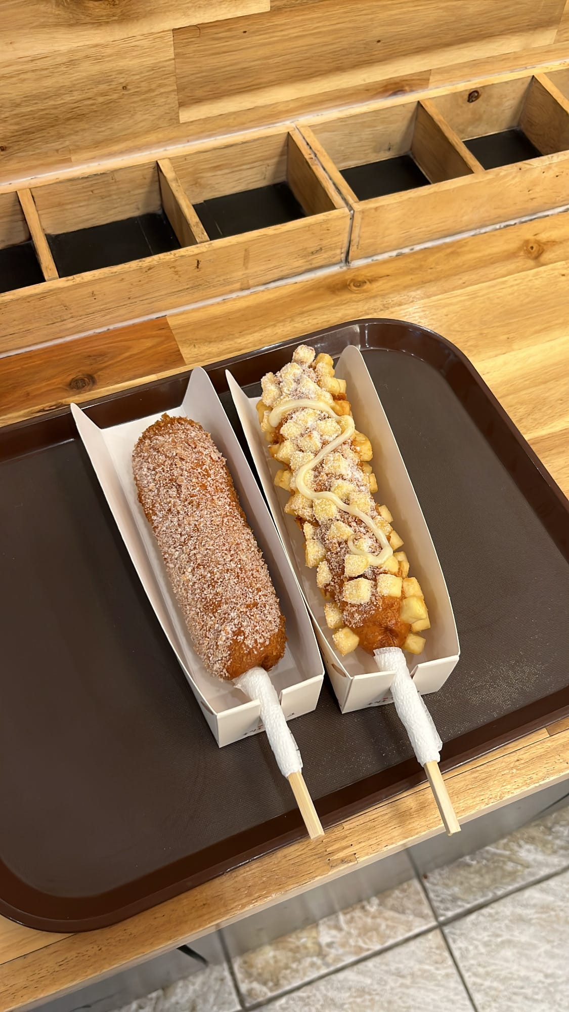Mozzarella corn dog and shredded potatoes corn dog served on a tray