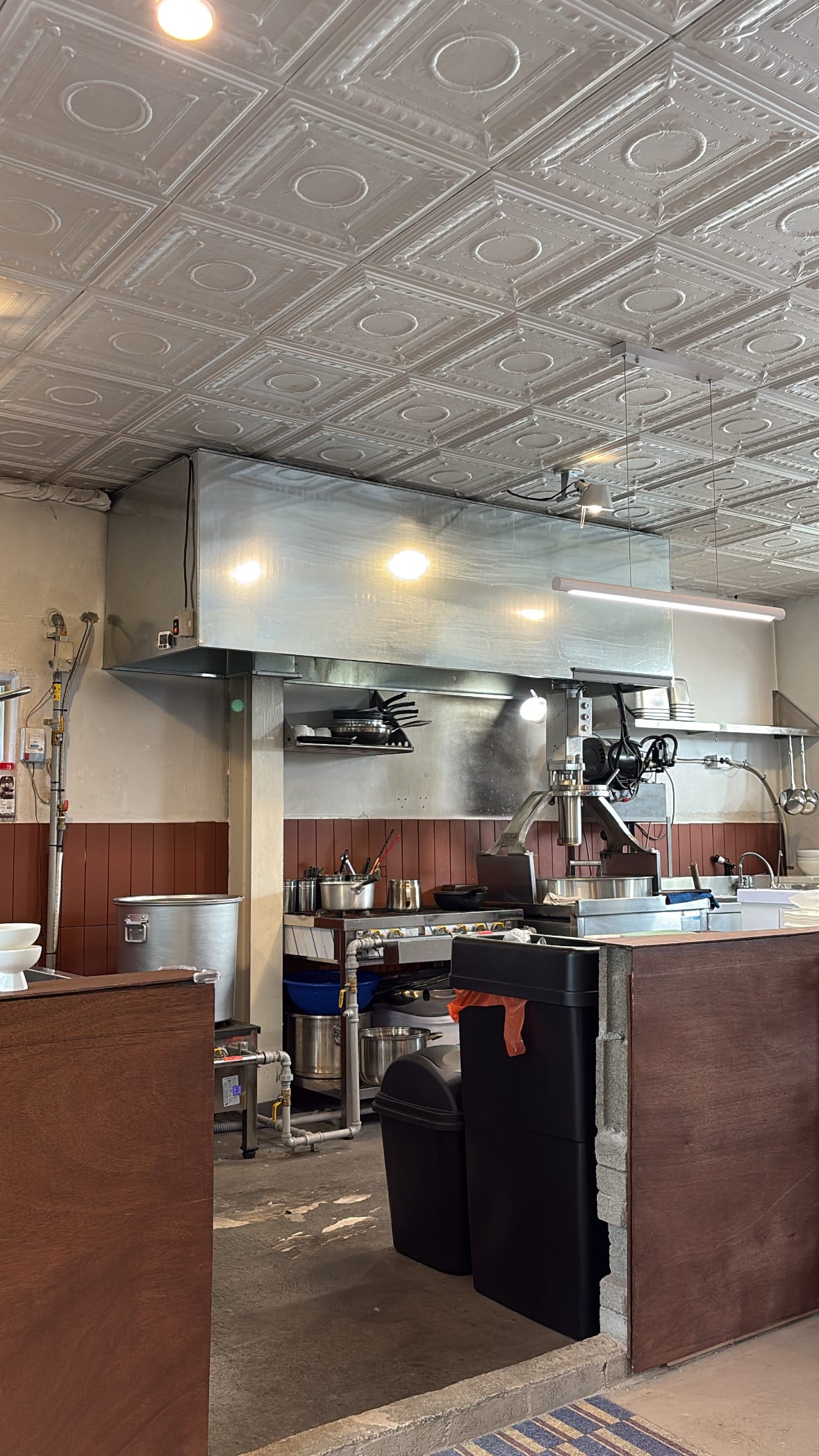 Open kitchen counter and stainless-steel noodle press at Yangkyungoak Busan