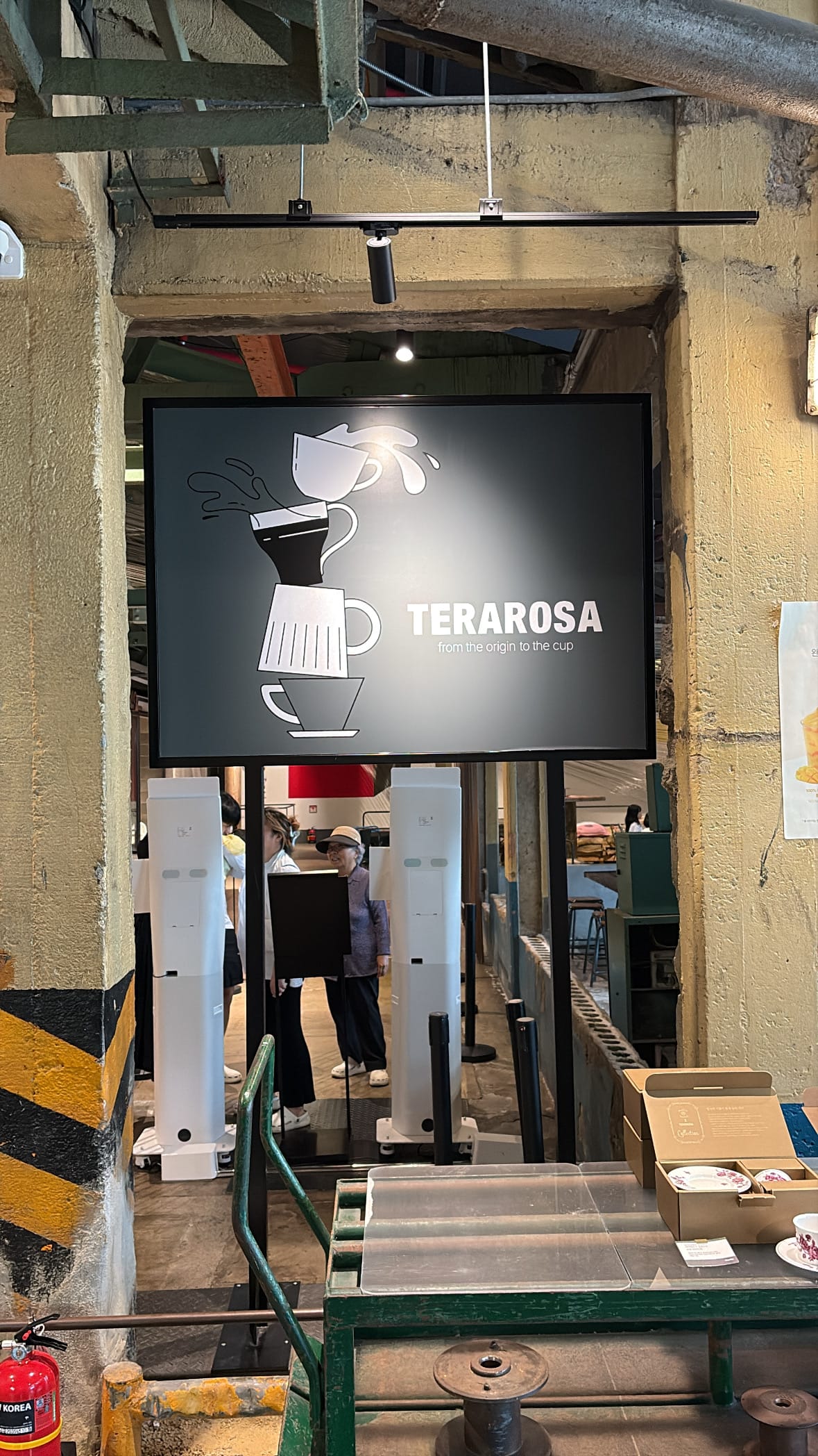 Terarosa Suyeong F1963 self-ordering kiosks under large logo board
