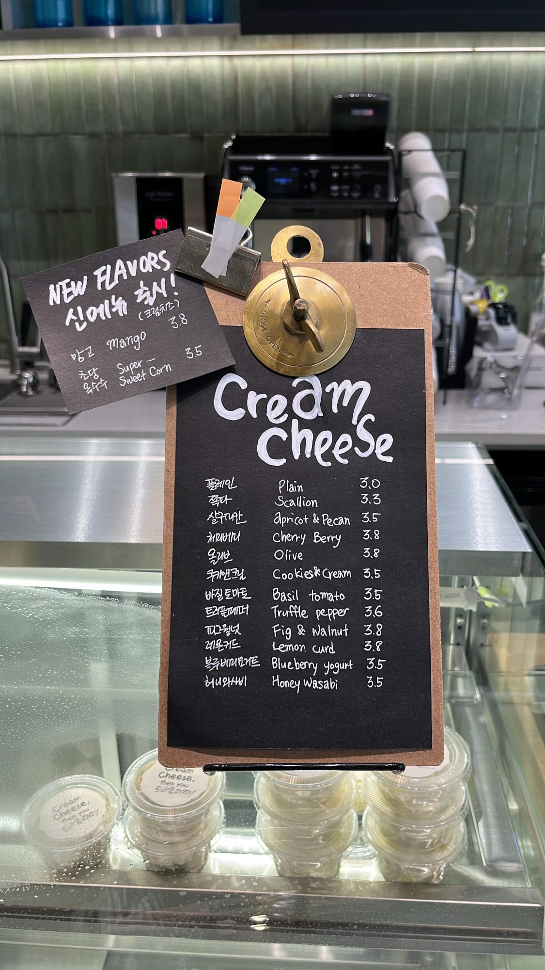 Clip menu board listing handcrafted cream cheese flavors and prices at Bagel Then You Busan Centum