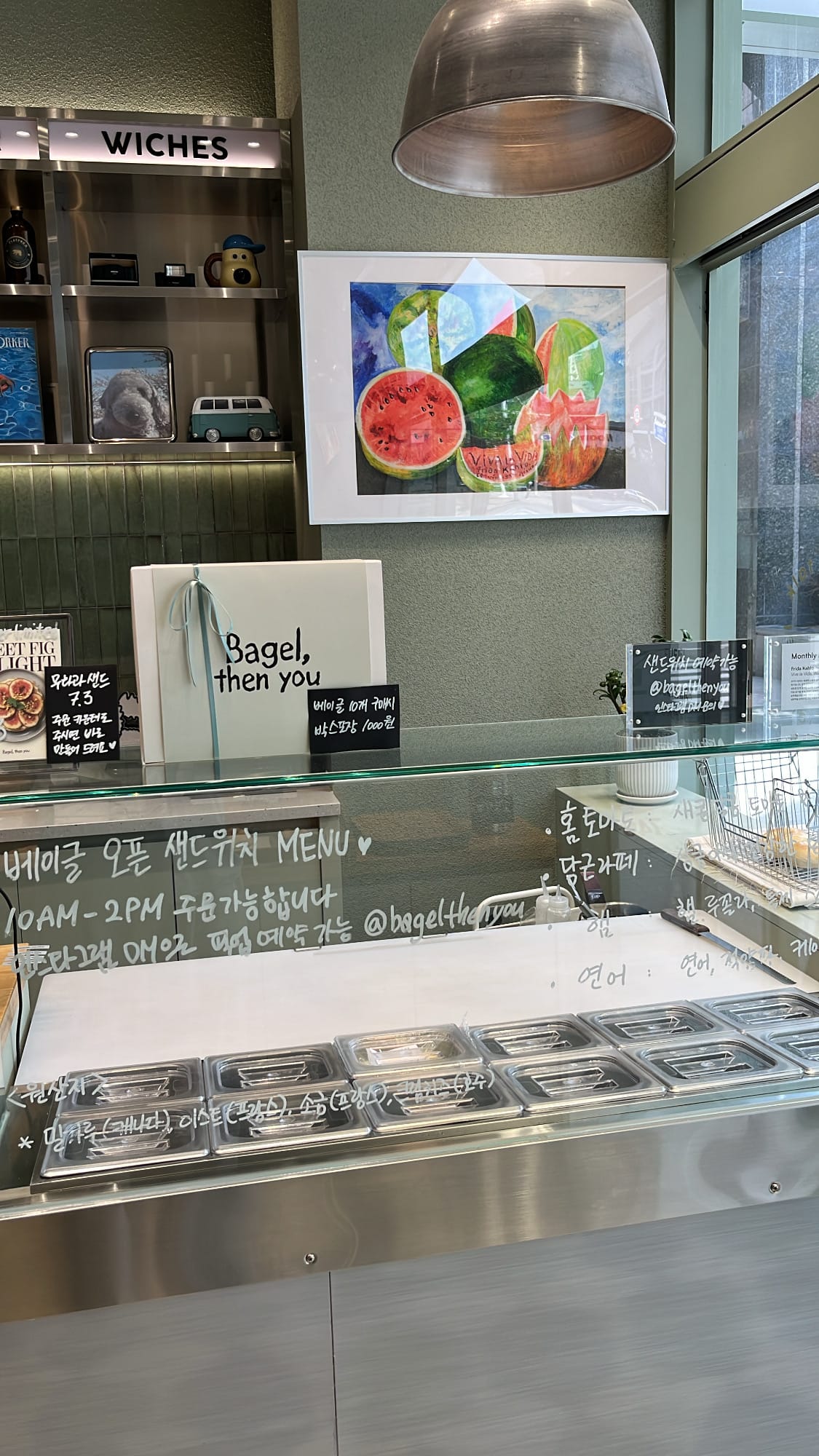 Open sandwich preparation station with fresh ingredient containers at Bagel Then You Busan Centum