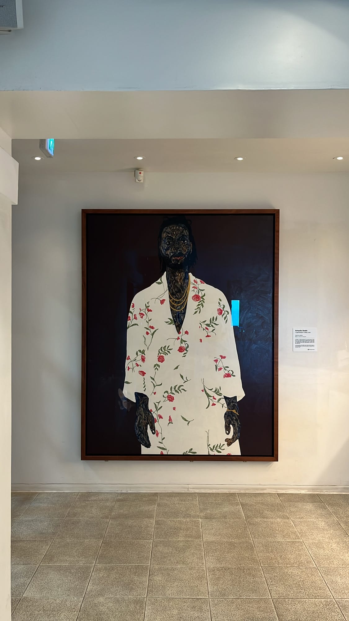 Large contemporary art piece displayed on the white wall inside Bibibidang