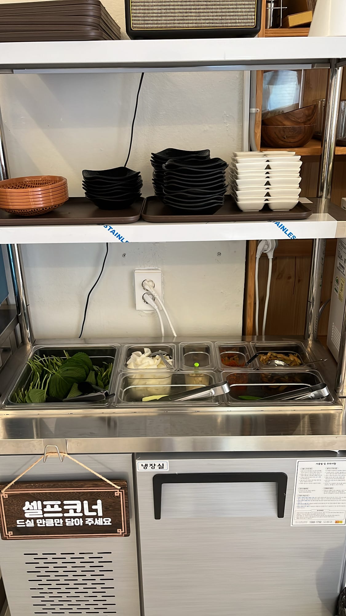Self-service refill bar with perilla leaves and banchan at Chef202 Busan