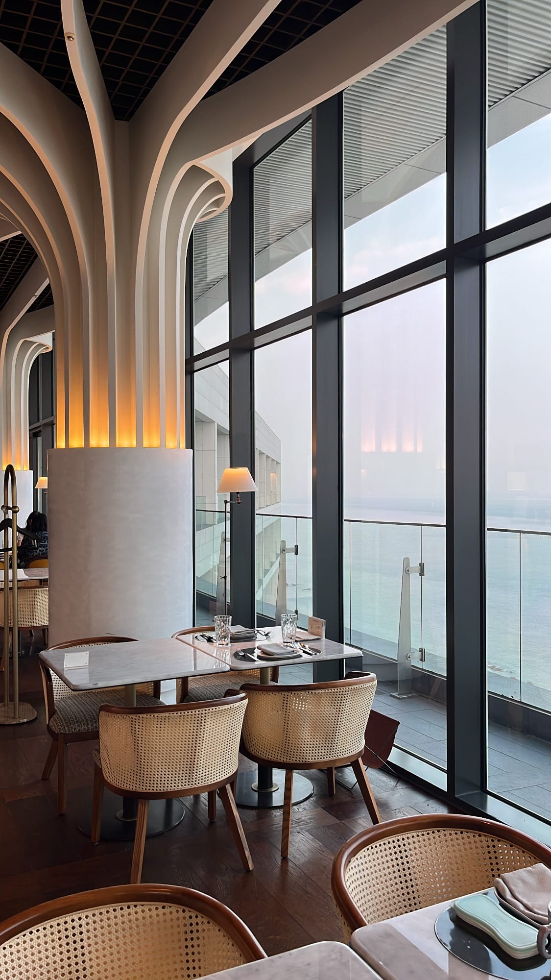 Sculptural arched ceiling and coastal window alcove at McQueen's Grill and Bar