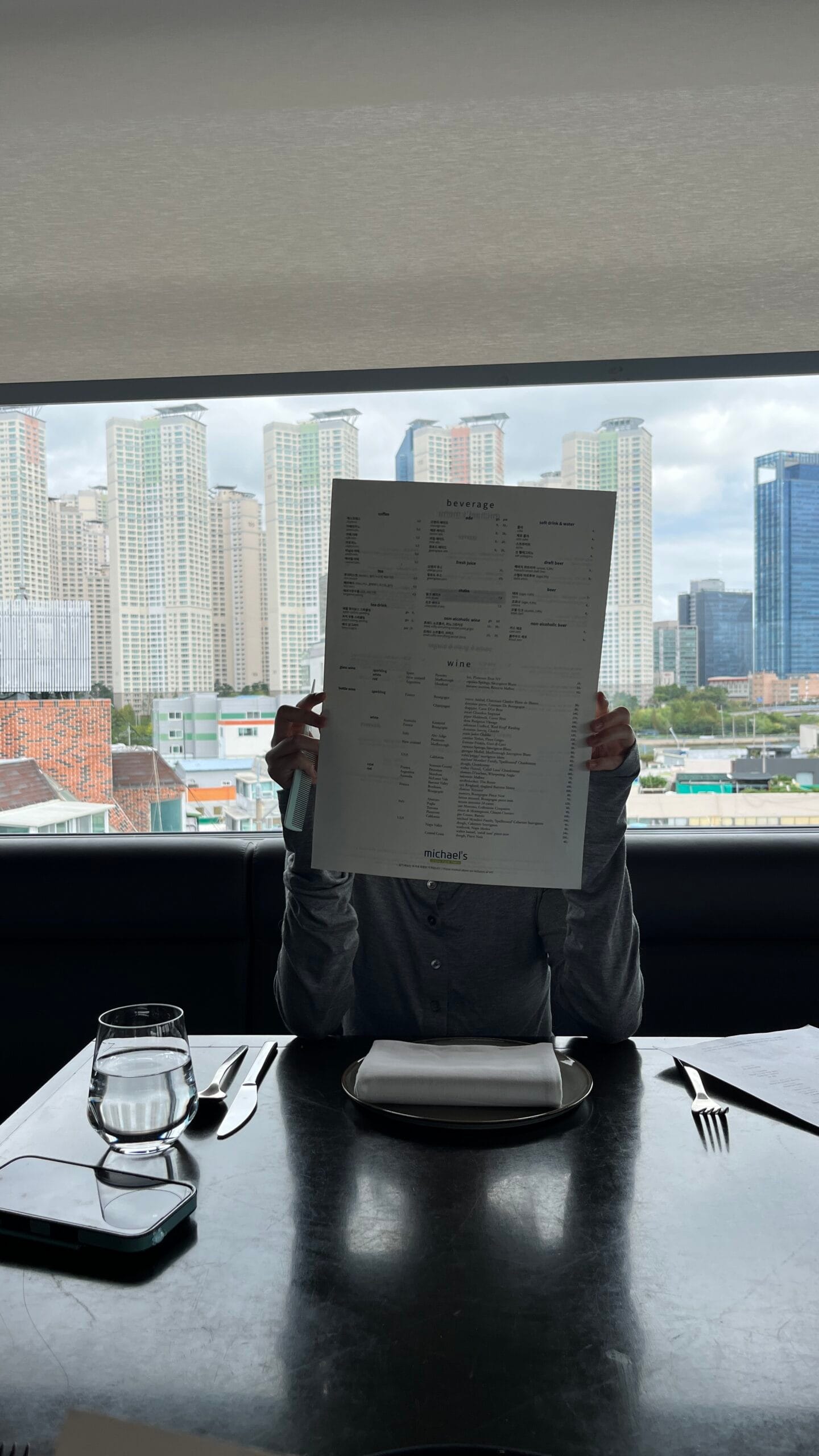 Guest reviewing the extensive wine and beverage list at the table