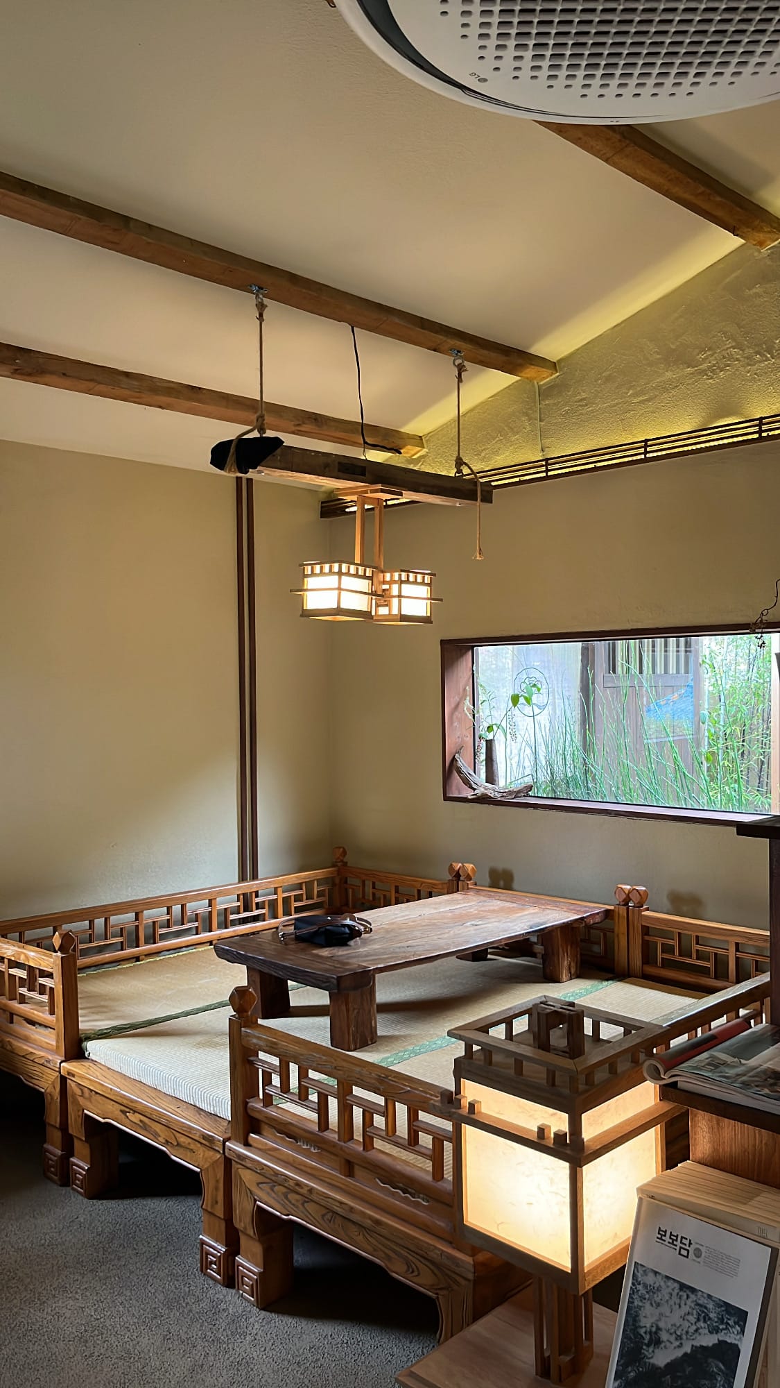 Spacious traditional wooden seating area with tatami mats at Simmian Busan