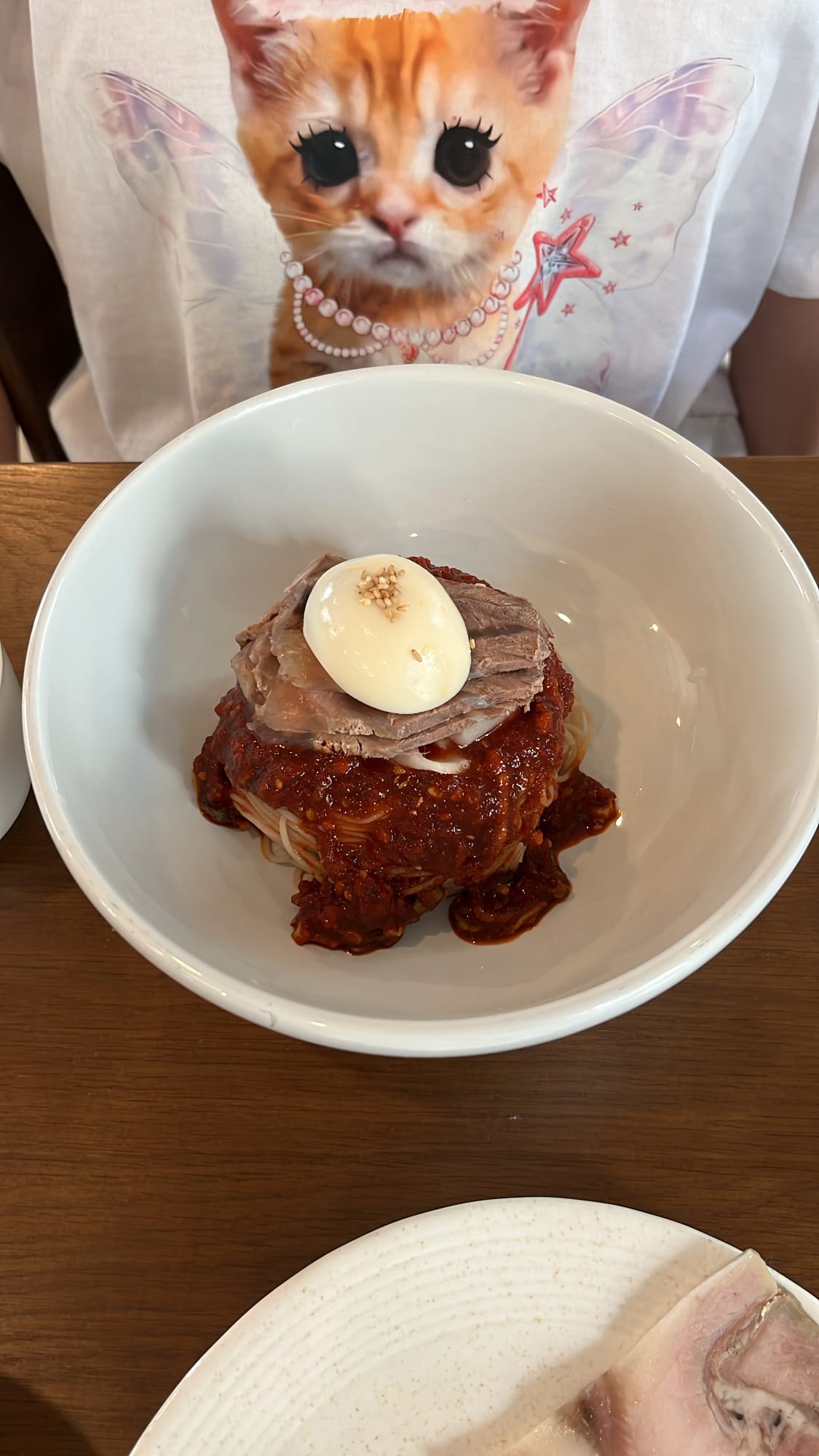 Spicy bibim naengmyeon served in white porcelain bowl at Yangkyungoak Busan