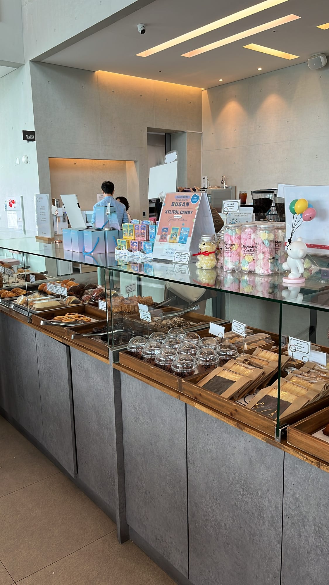 Glass bakery display counter offering fresh daily breads and gifts at Coralani Busan