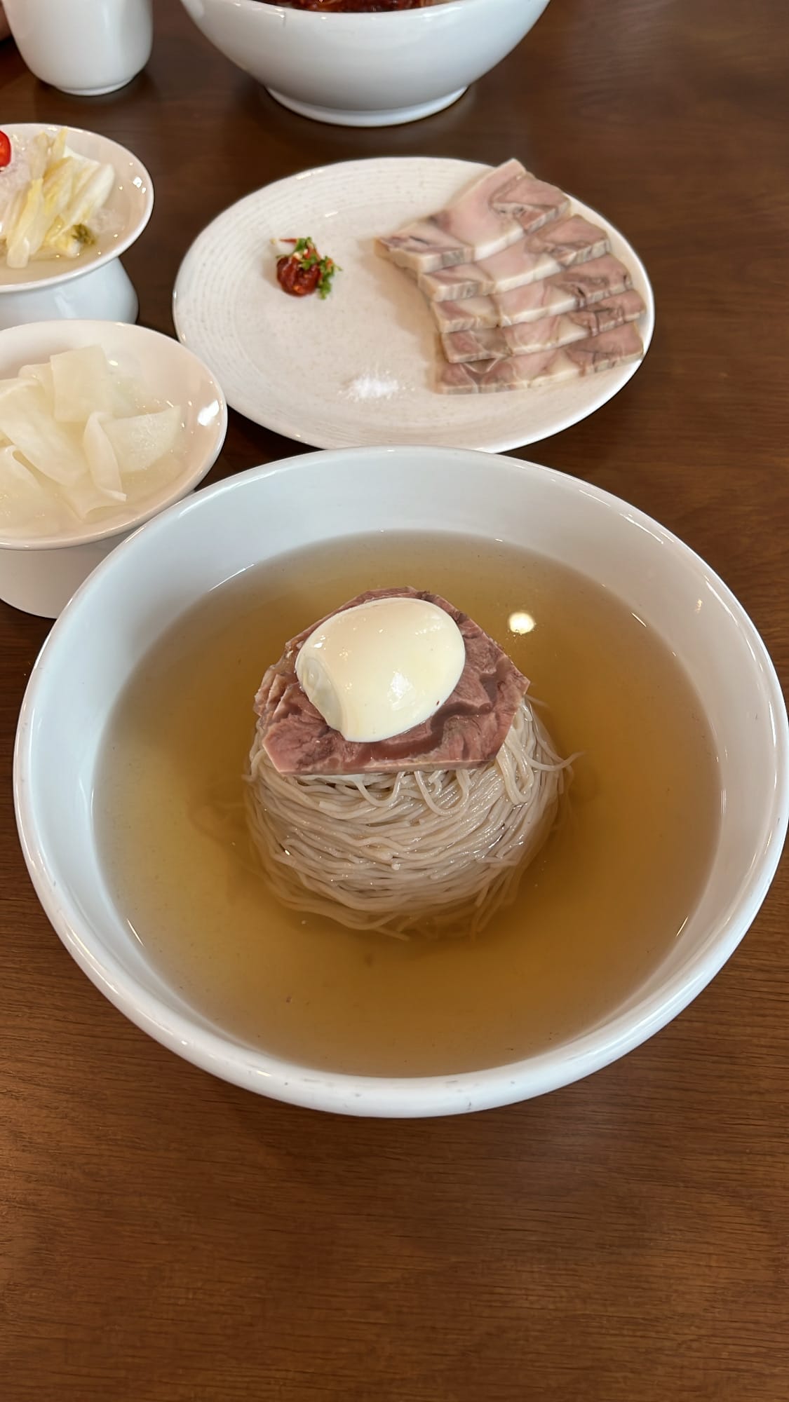 Authentic Pyongyang naengmyeon in crystal-clear chilled beef broth at Yangkyungoak Busan