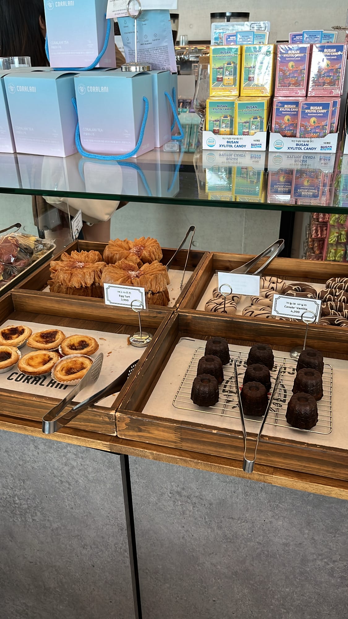 Freshly baked caneles, egg tarts, and flaky pastries at Coralani Busan