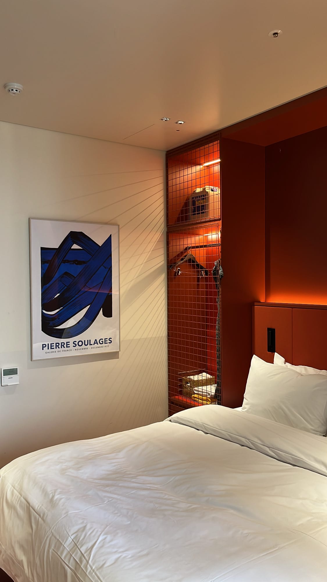 Pierre Soulages art print hanging above the bed at The Coolest Hotel
