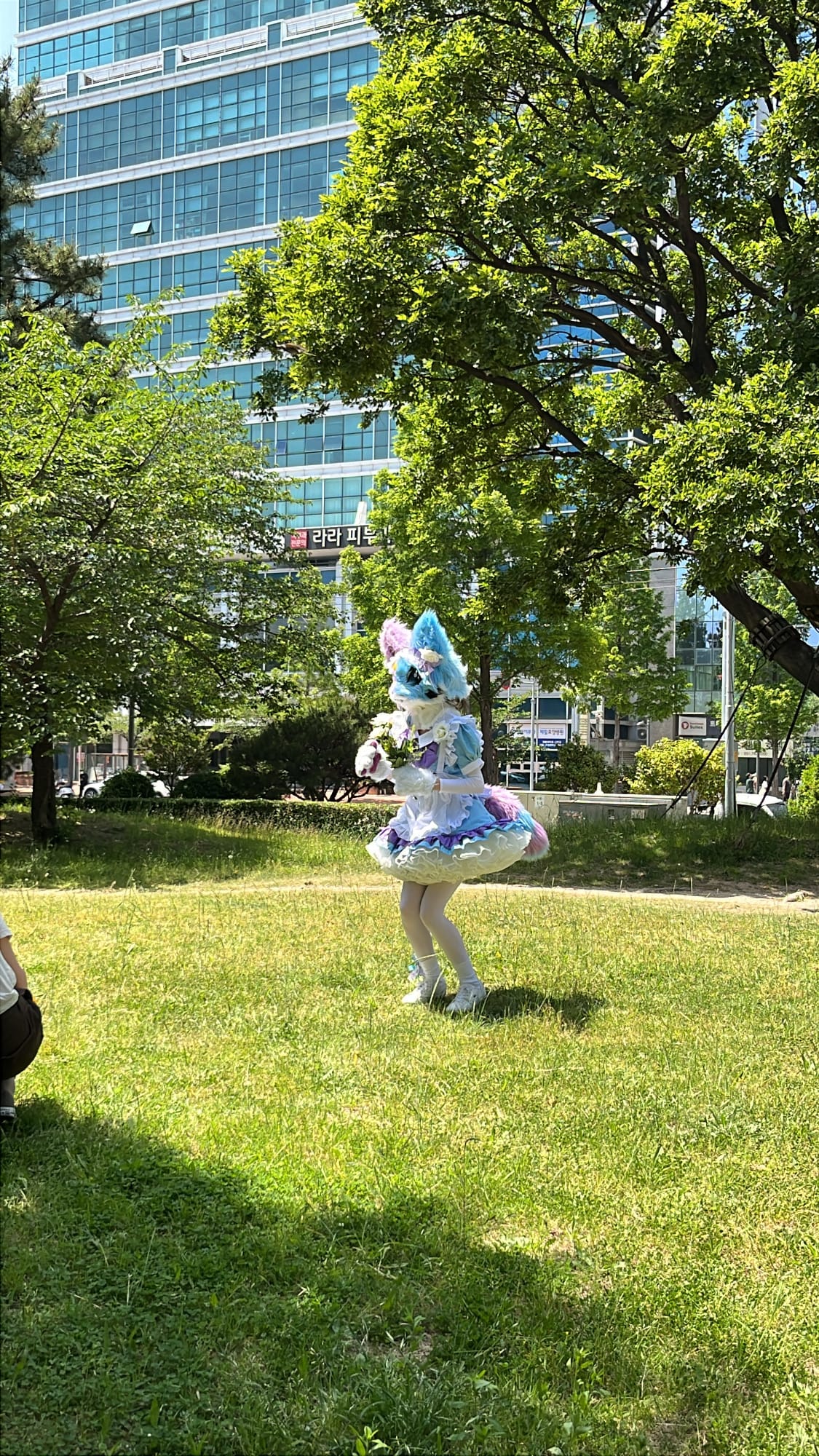 Pastel blue and pink maid fursuit cosplayer posing on BEXCO lawn