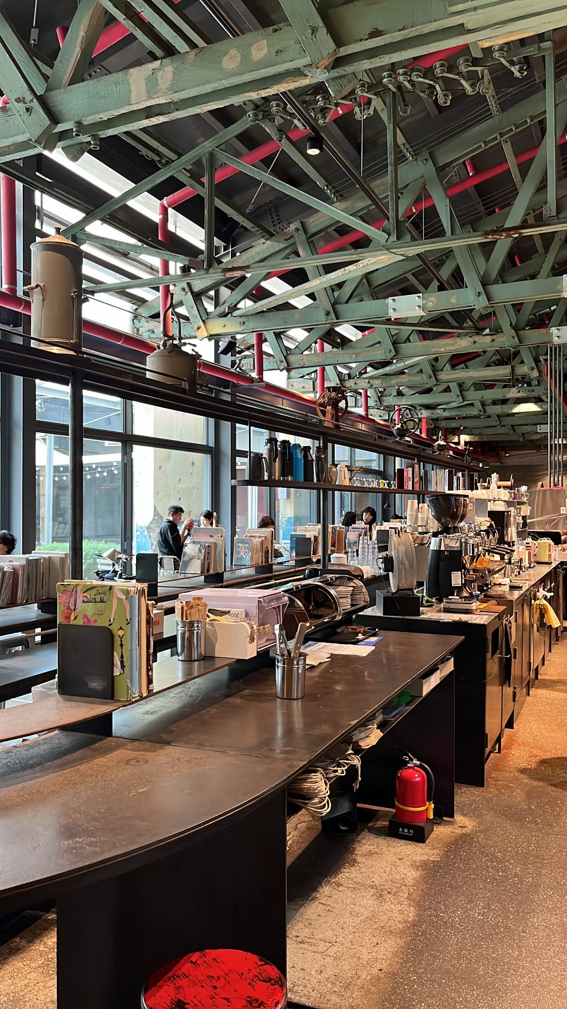 Extended coffee bar counter with reading materials overlooking terrace