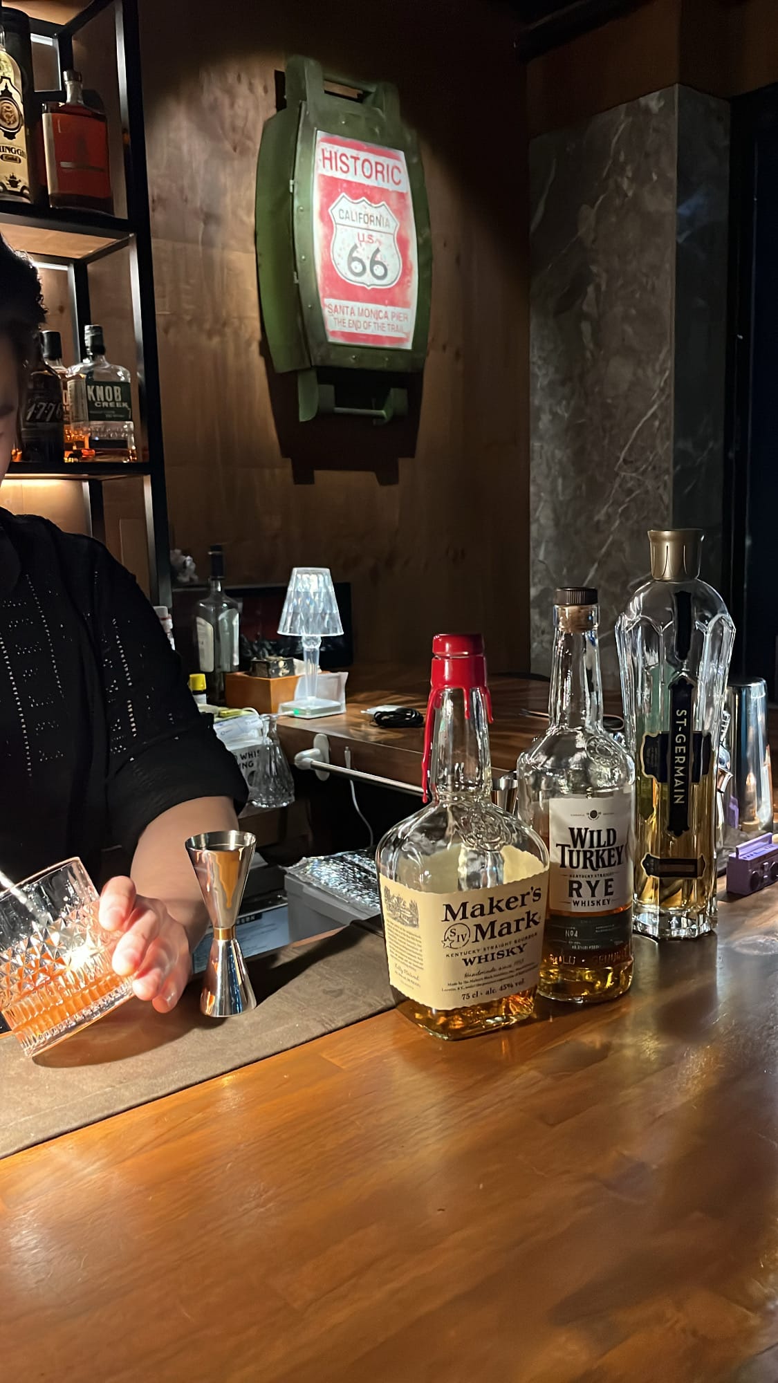 Maker's Mark Bourbon and Wild Turkey Rye on counter for Old Fashioned