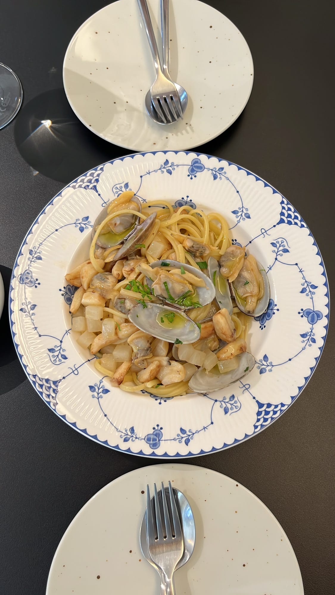 Danicci top-down view of garlic and clam vongole pasta dish