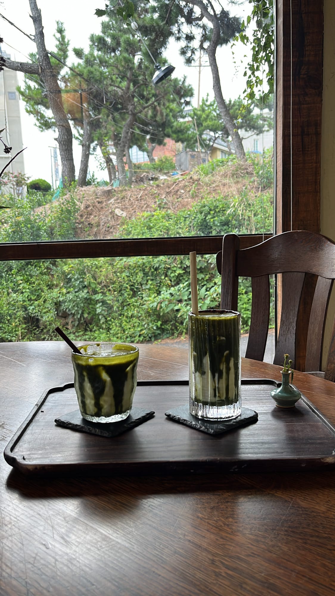 Signature matcha latte and matcha chocolate latte served on a wooden tray