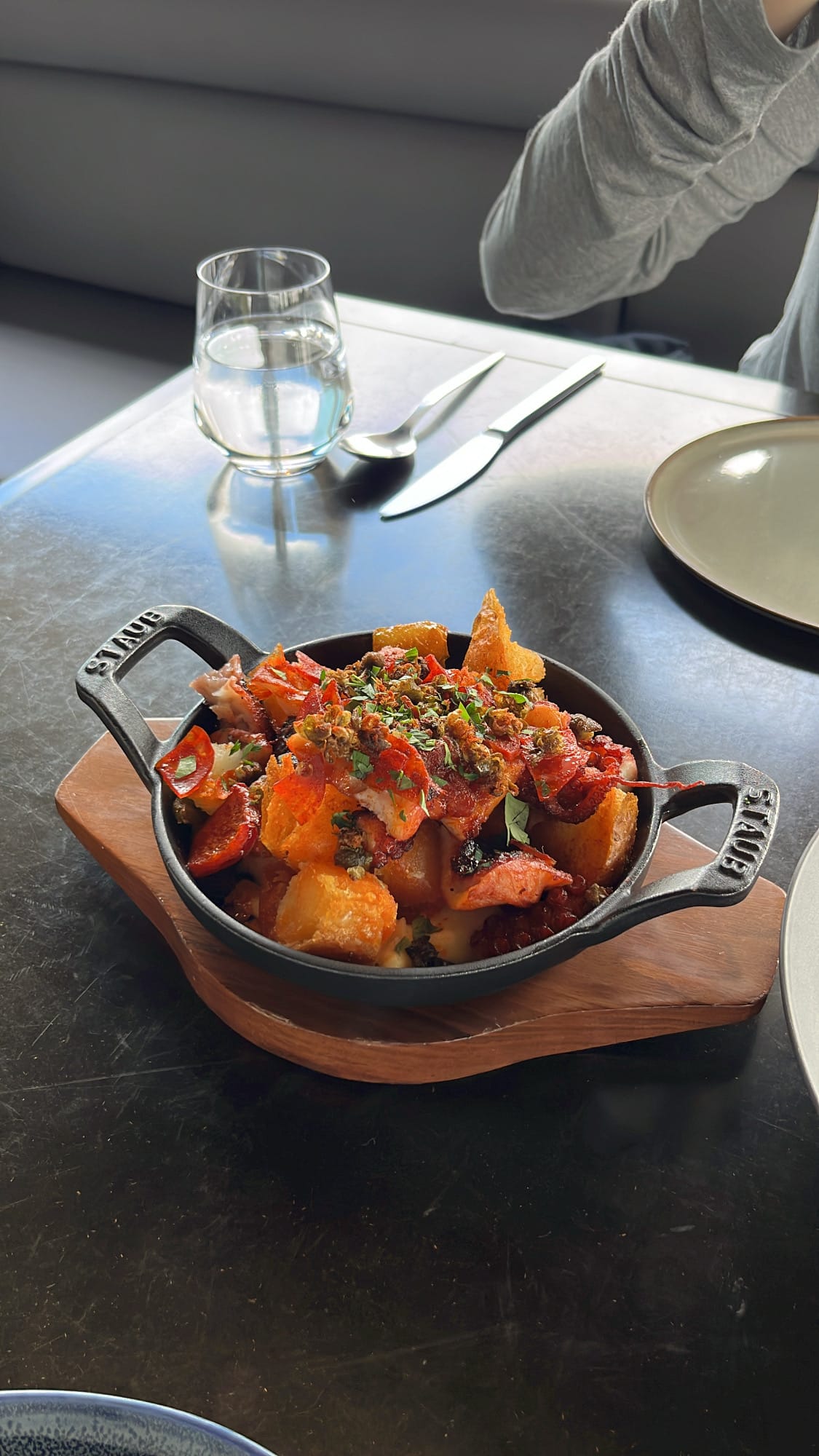 Signature tender octopus and crispy roasted potatoes in a Staub pan