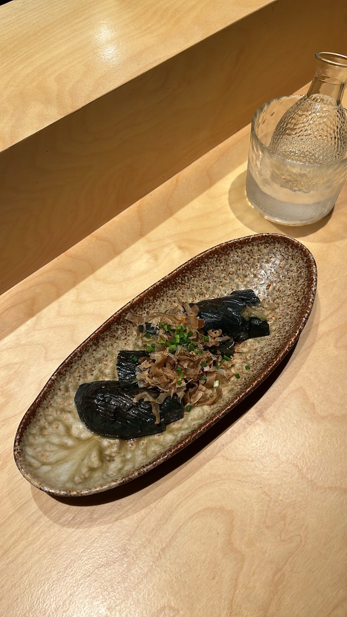 Close-up top view of fried and simmered nasu nibitashi at Murasaki Busan