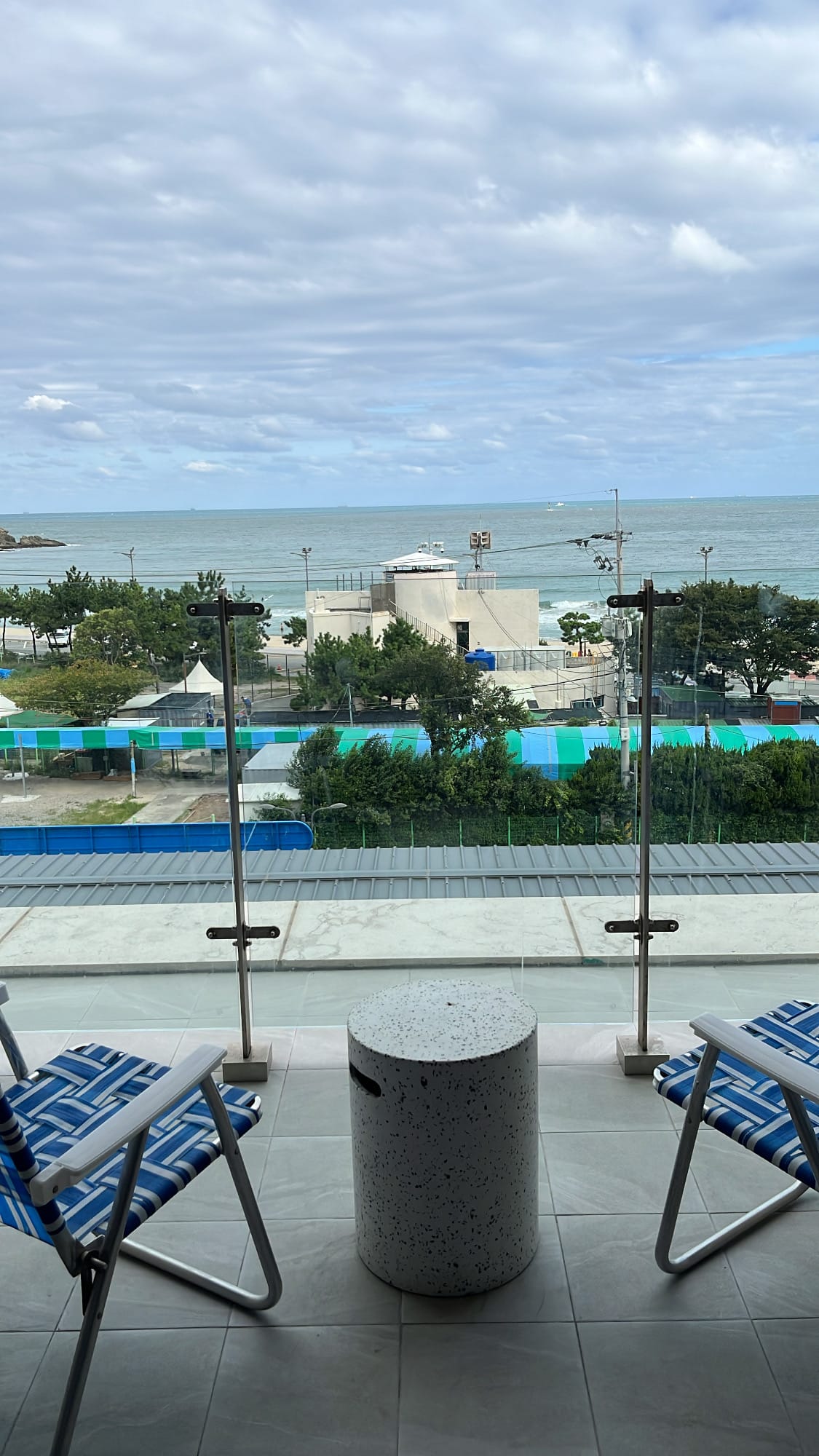 Private balcony terrace with folding chairs and table at The Coolest Hotel