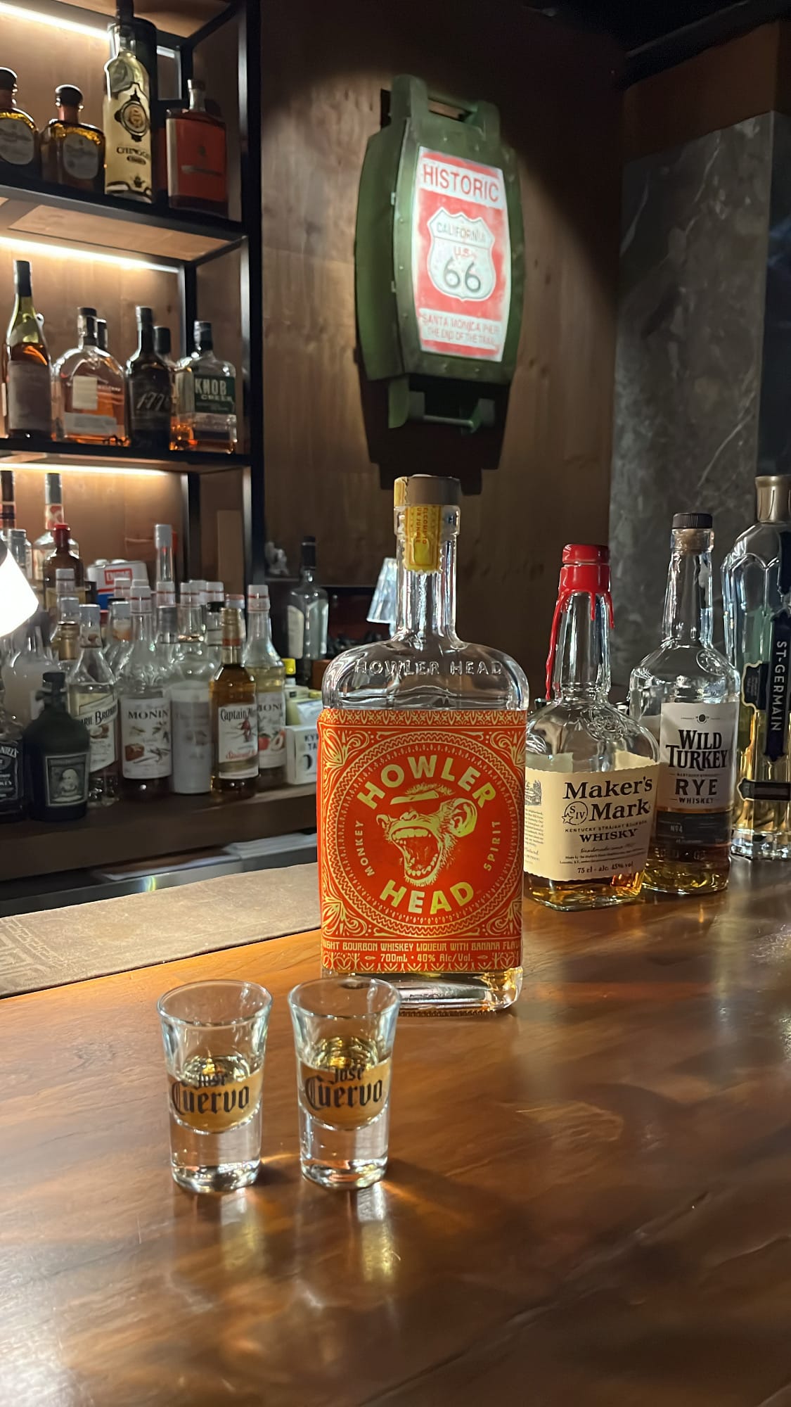 Howler Head banana flavored bourbon bottle with two shot glasses