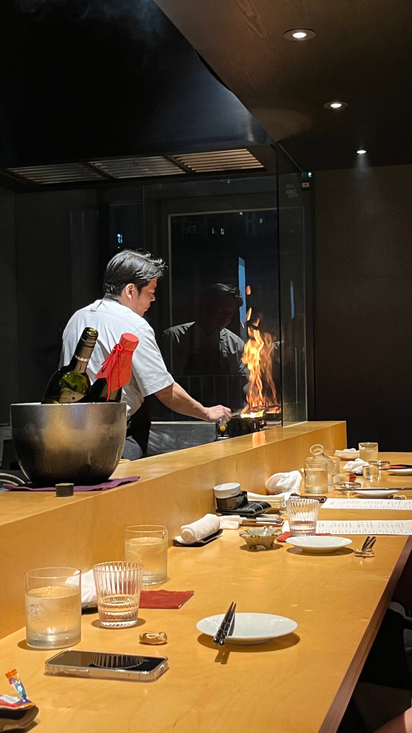 Cozy evening dining atmosphere with open straw grill flames at Murasaki Busan
