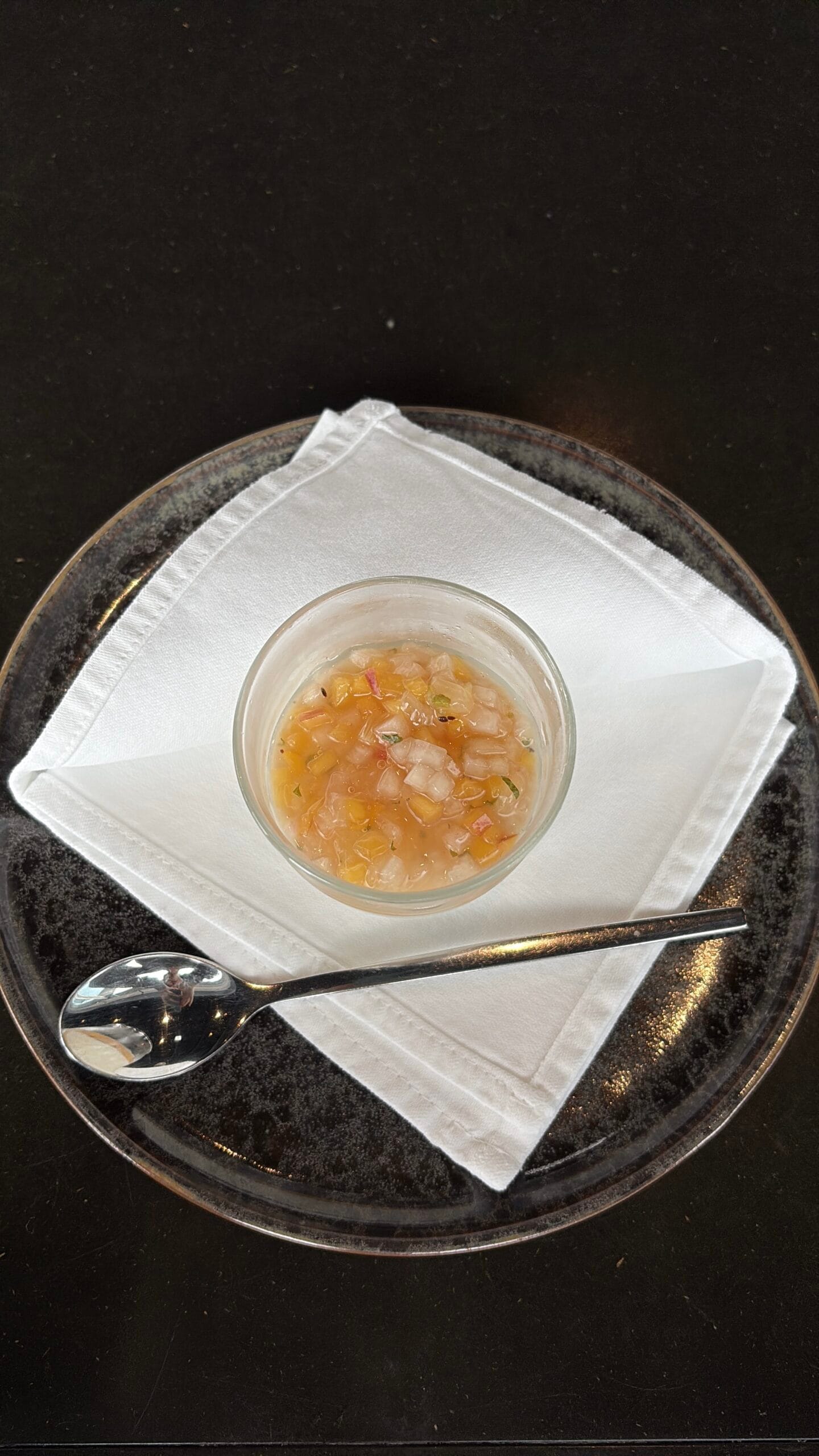 Top view of creamy panna cotta topped with sweet diced citrus compote