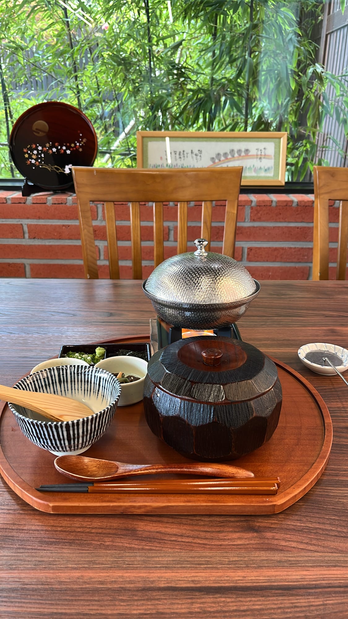 Covered lacquer bowl of hitsumabushi and boiling pot of yosenabe soup on wooden tray at Unaju Busan