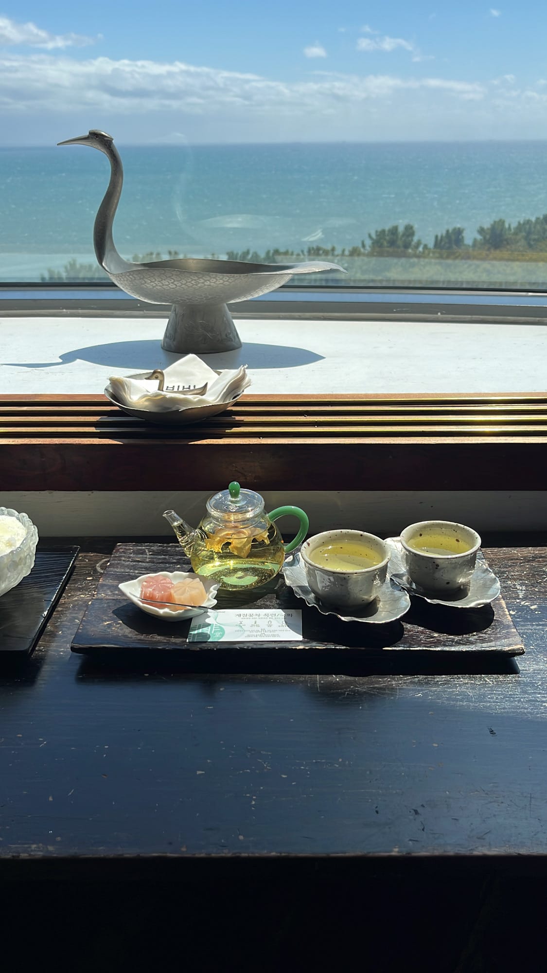 Magnolia flower tea set served in a glass teapot with handmade sweet red bean jelly