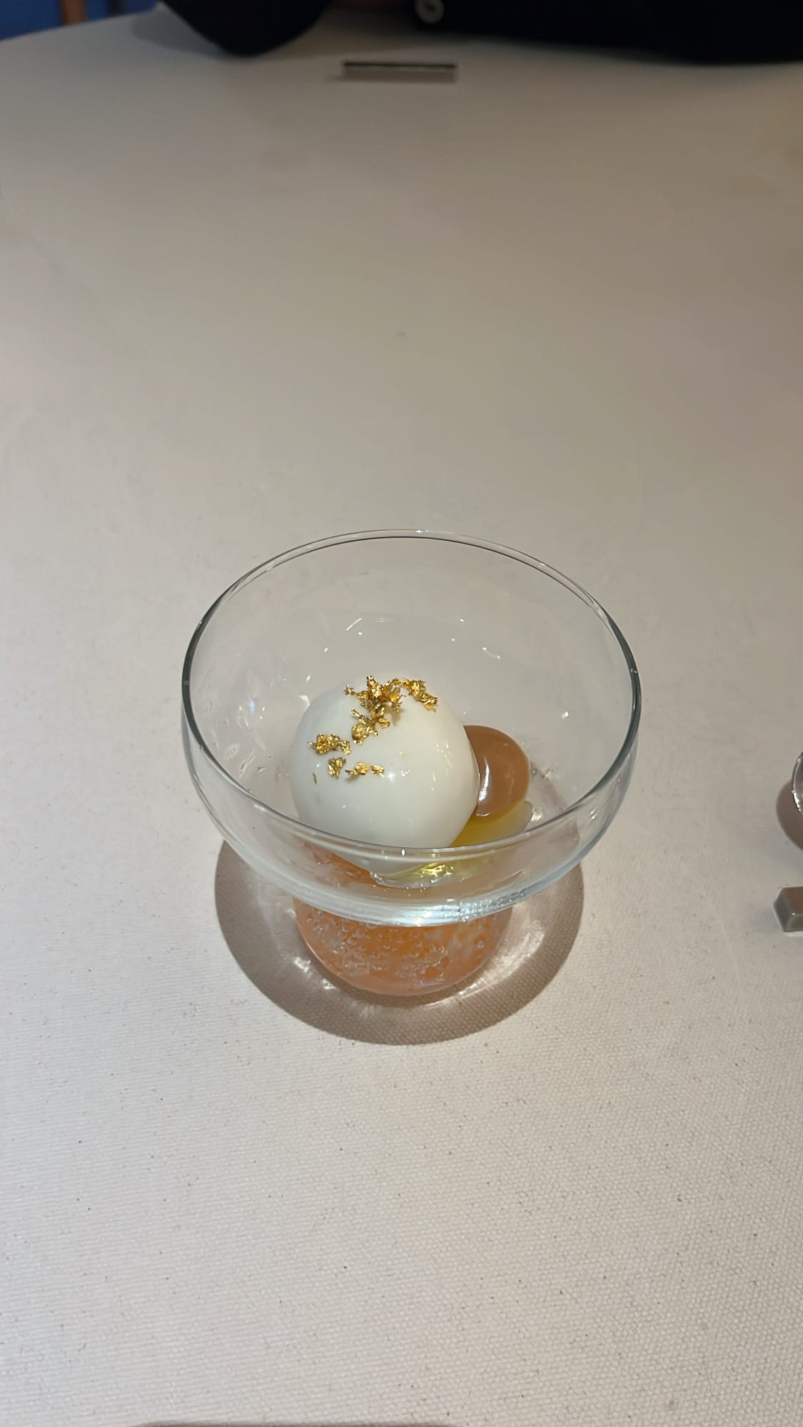 Artful sweet and sour ice cream dessert with gold leaf