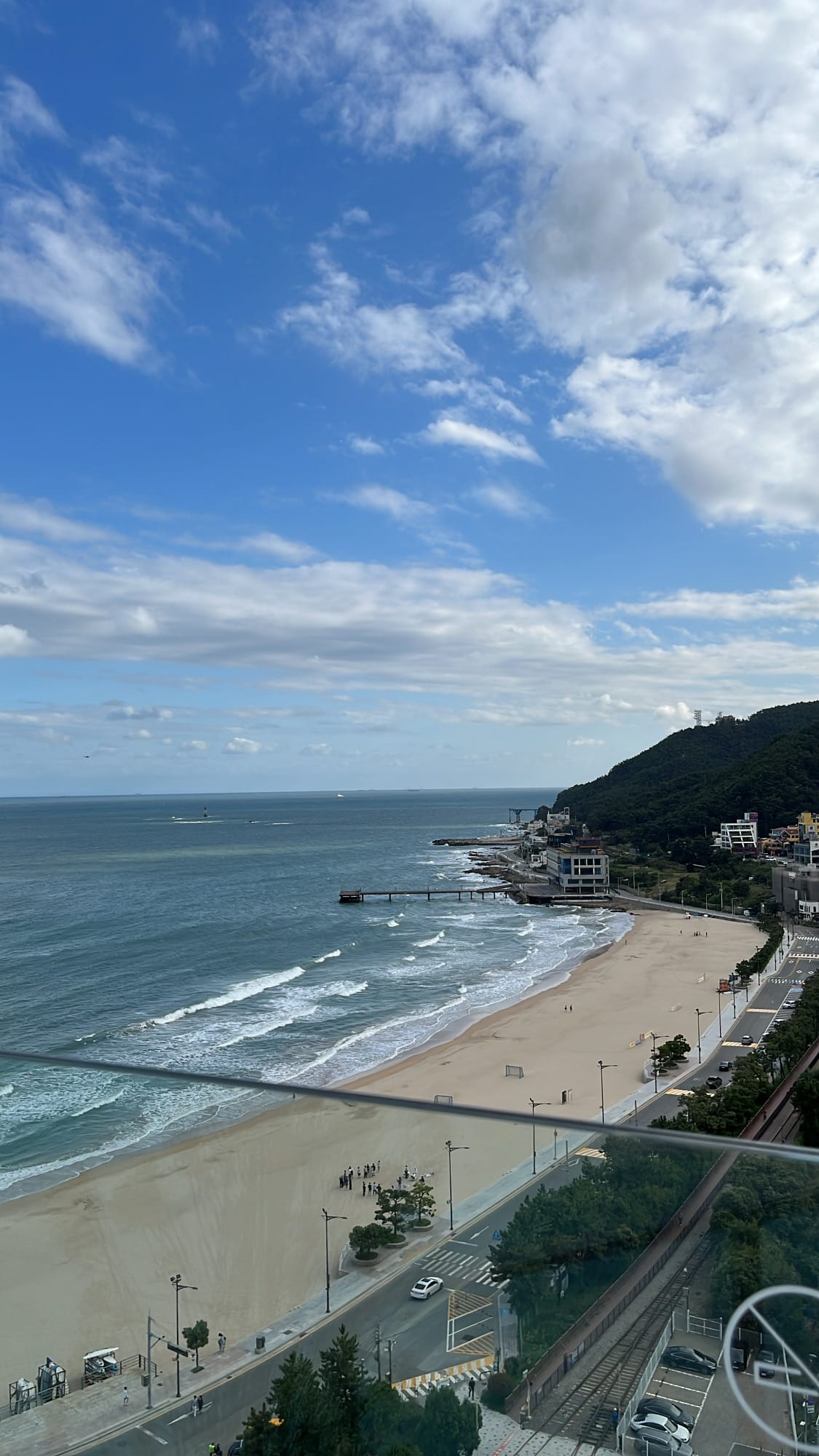 Panoramic view of Songjeong Beach crescent from the hotel rooftop