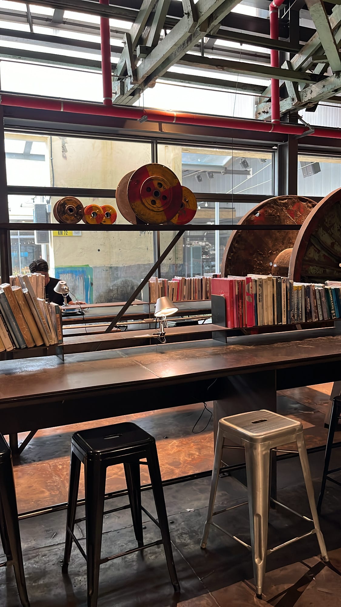Bar seating counter surrounded by books and mini reading lamps