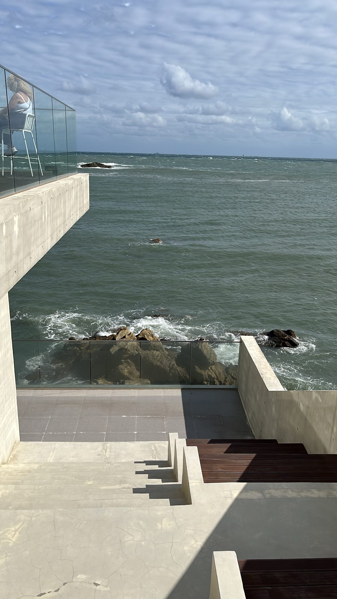 Quiet hidden outdoor terrace nook tucked between floor levels at Coralani Busan