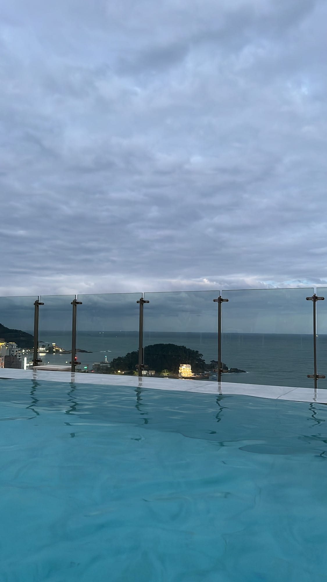 Rooftop heated pool glowing gently as dusk settles over Songjeong