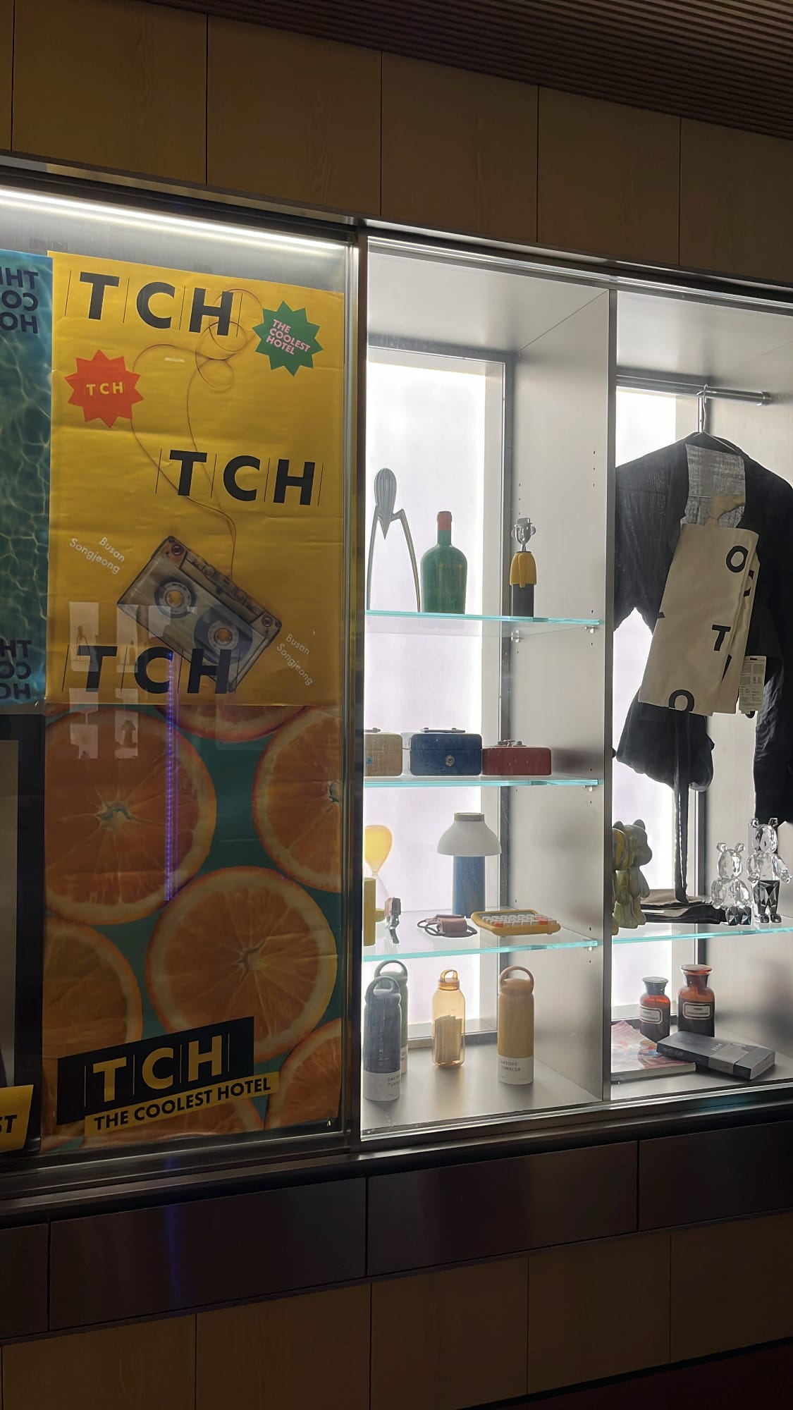 TCH design poster and curated hotel merchandise cabinet
